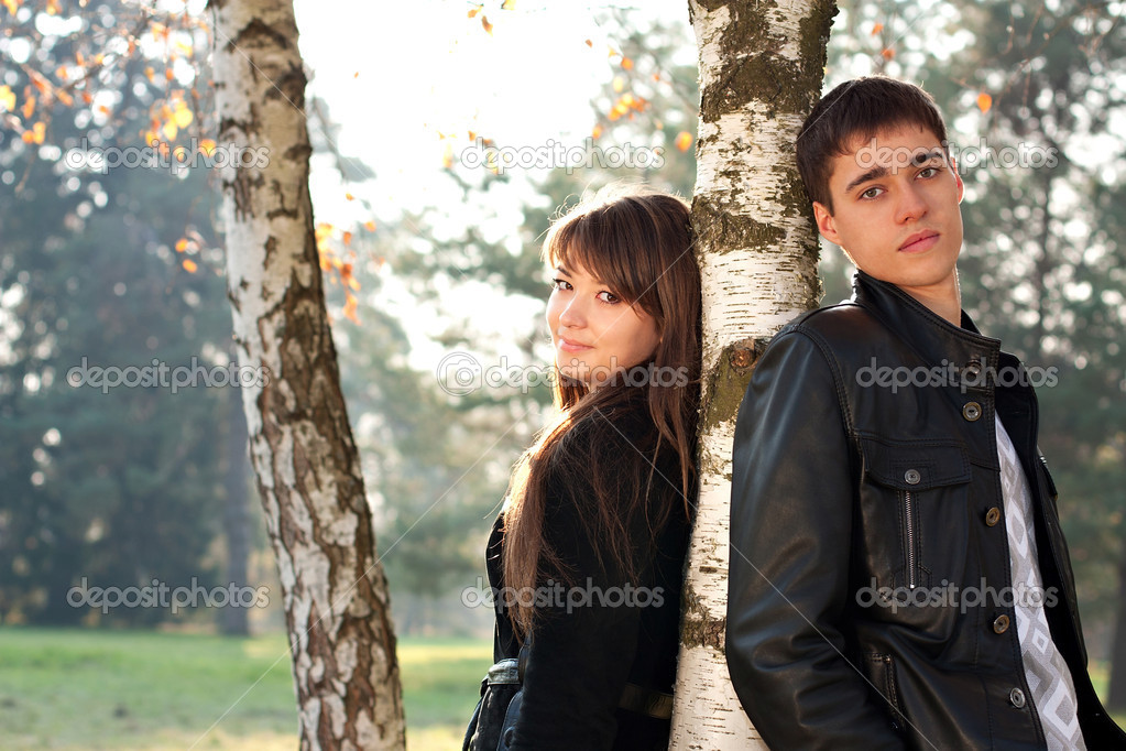 2 молодые девушки и парень. Парень и девушка стоят рядом. Девушка и парень возле дерева. Парень и девушка у дерева. Парень у березы.