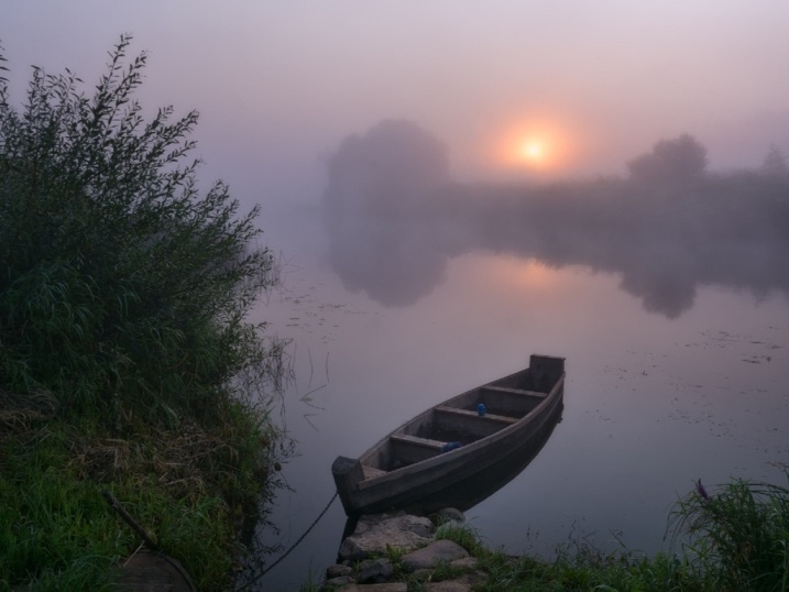 Рыбак на лодке в тумане